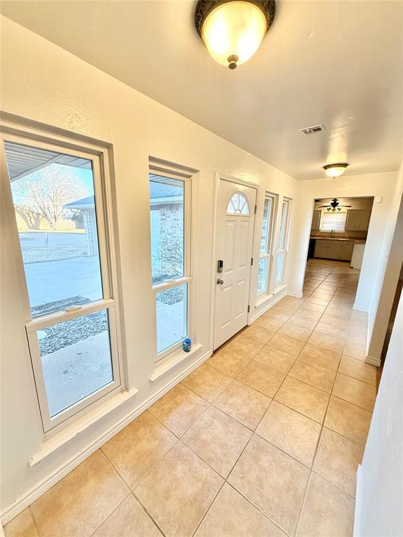 entrance foyer with light tile patterned floors