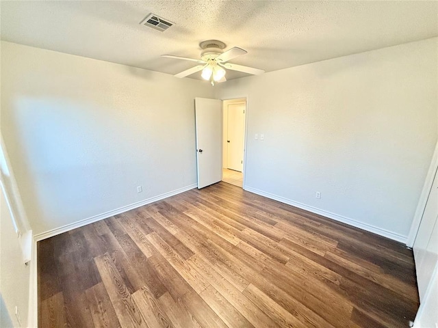 unfurnished room with ceiling fan, hardwood / wood-style floors, and a textured ceiling