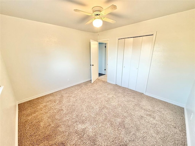 unfurnished bedroom featuring light colored carpet, ceiling fan, and a closet