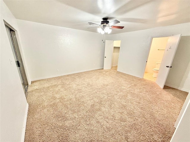 unfurnished bedroom featuring light carpet, connected bathroom, a closet, and ceiling fan