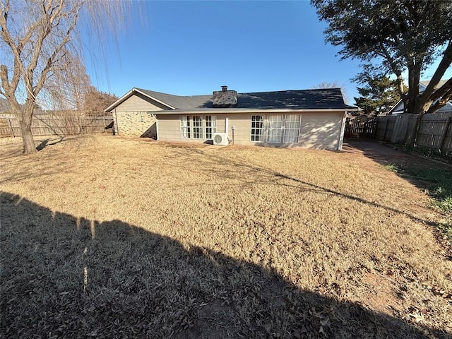 back of house featuring a yard and ac unit