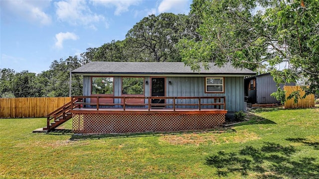 back of property featuring a yard and a wooden deck