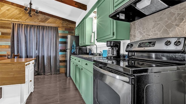 kitchen with green cabinets, lofted ceiling with beams, and appliances with stainless steel finishes