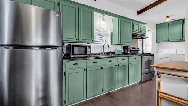 kitchen with appliances with stainless steel finishes, a wealth of natural light, washer and clothes dryer, beamed ceiling, and green cabinets