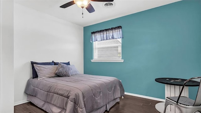 bedroom with ceiling fan and dark hardwood / wood-style flooring