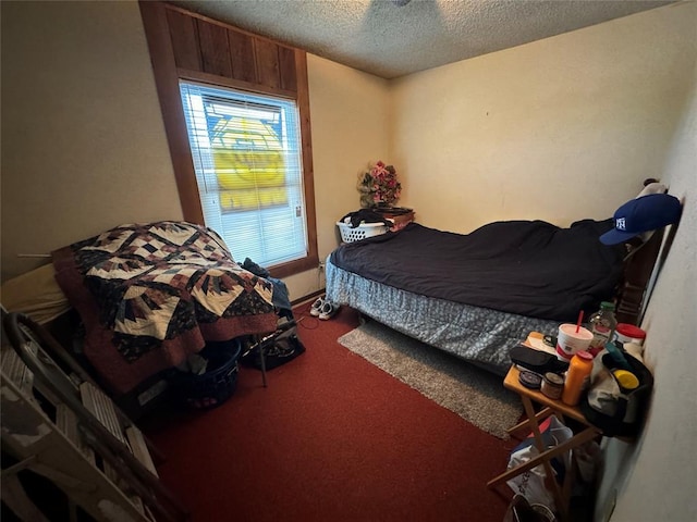 bedroom featuring a textured ceiling and carpet