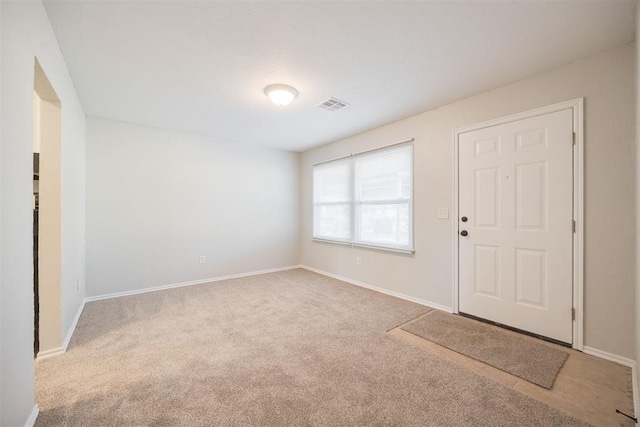 foyer entrance with light colored carpet