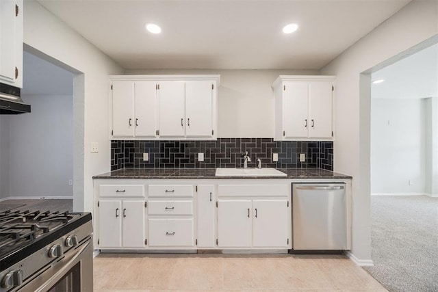 kitchen with sink, white cabinetry, dishwasher, and light carpet