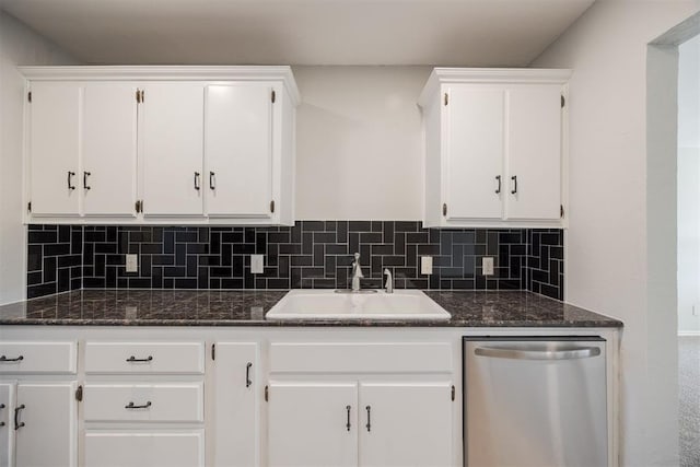 kitchen featuring white cabinets, stainless steel dishwasher, tasteful backsplash, and sink