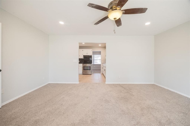 interior space with ceiling fan and light carpet