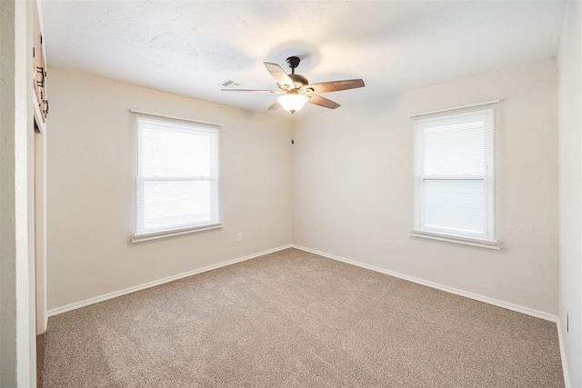 unfurnished room with ceiling fan and carpet floors