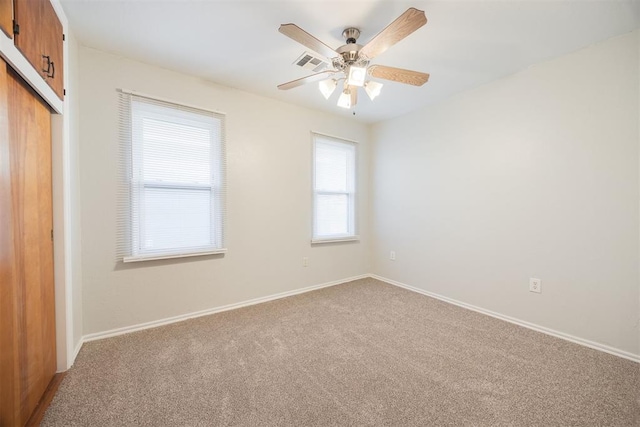 carpeted empty room featuring ceiling fan