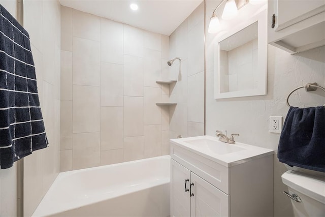 full bathroom with toilet, vanity, and tiled shower / bath