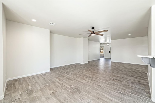 unfurnished living room featuring ceiling fan and light hardwood / wood-style floors