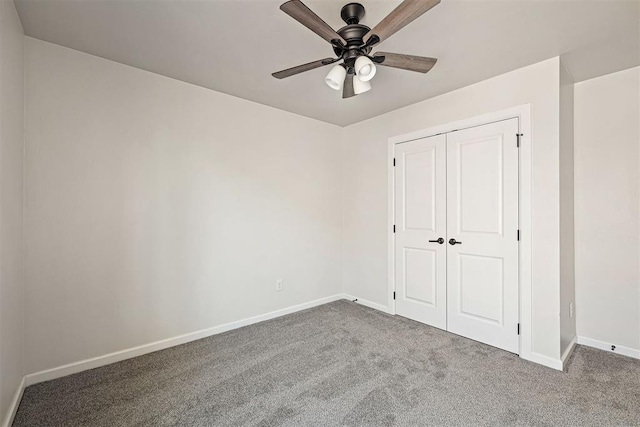 unfurnished bedroom featuring ceiling fan, a closet, and carpet floors