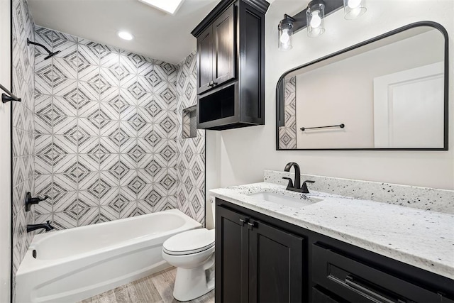 full bathroom featuring tub / shower combination, hardwood / wood-style floors, toilet, and vanity