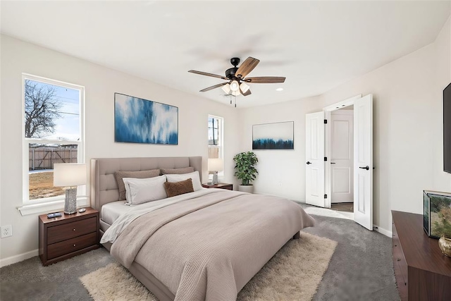 carpeted bedroom featuring ceiling fan and multiple windows