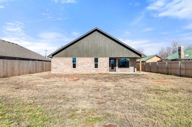 back of house with a lawn