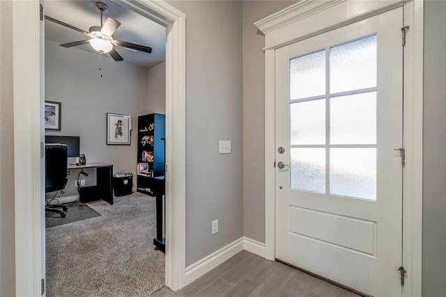 entryway featuring ceiling fan and light colored carpet