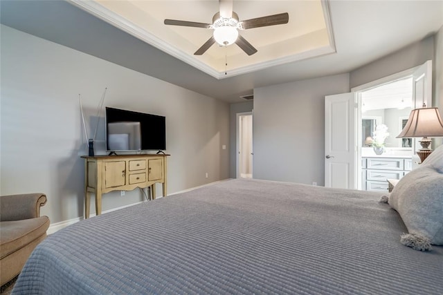 bedroom with ceiling fan and a raised ceiling