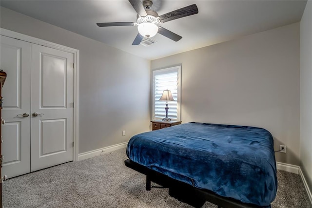 carpeted bedroom featuring ceiling fan and a closet