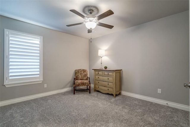 sitting room with ceiling fan and carpet flooring