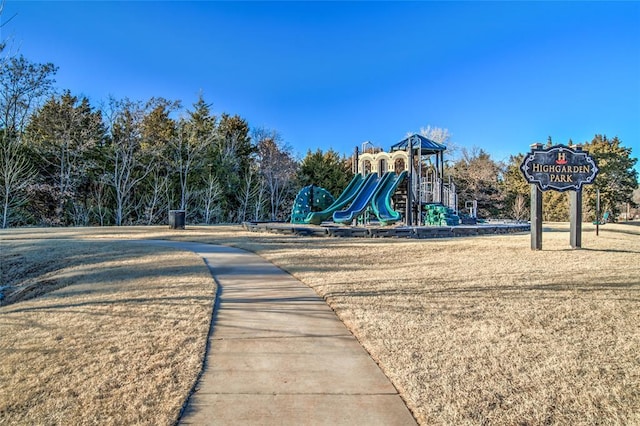 view of playground with a lawn