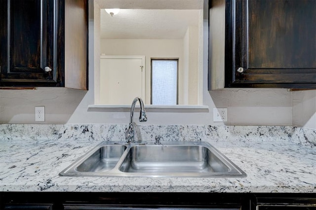 kitchen featuring sink and dark brown cabinetry