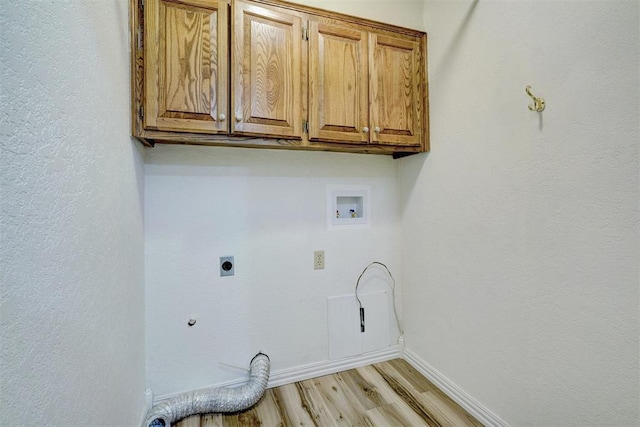 clothes washing area with light hardwood / wood-style flooring, electric dryer hookup, hookup for a washing machine, cabinets, and gas dryer hookup