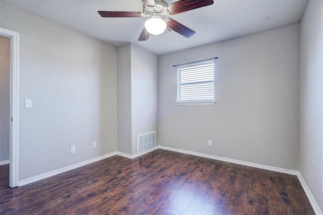 unfurnished room with dark wood-type flooring and ceiling fan