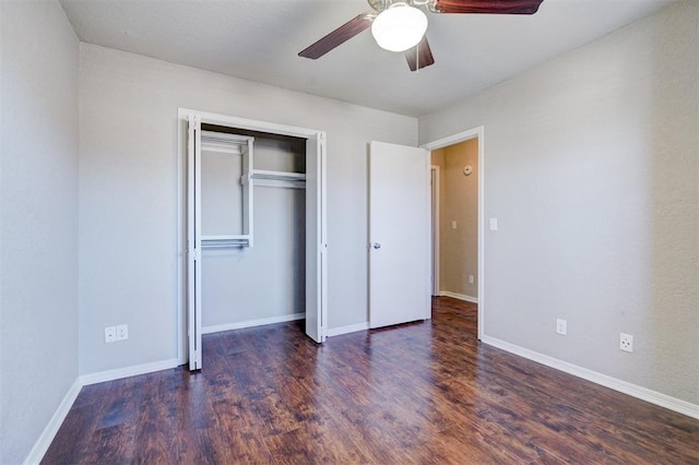 unfurnished bedroom with ceiling fan, dark hardwood / wood-style flooring, and a closet