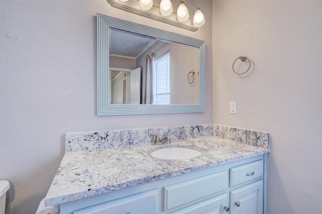 bathroom with vanity and ornamental molding