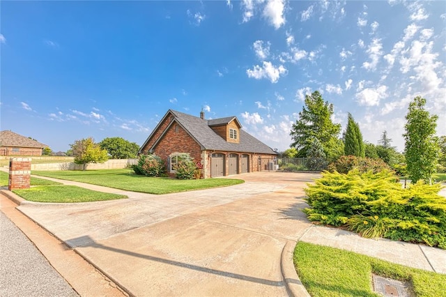 view of front of property with a garage and a front lawn