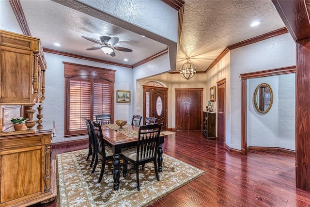 dining room with a textured ceiling, ornamental molding, and dark wood-type flooring