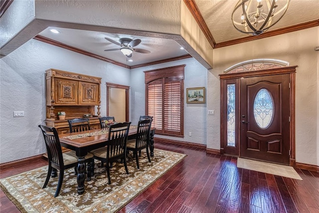 dining area featuring ceiling fan with notable chandelier, dark hardwood / wood-style flooring, a textured ceiling, and crown molding