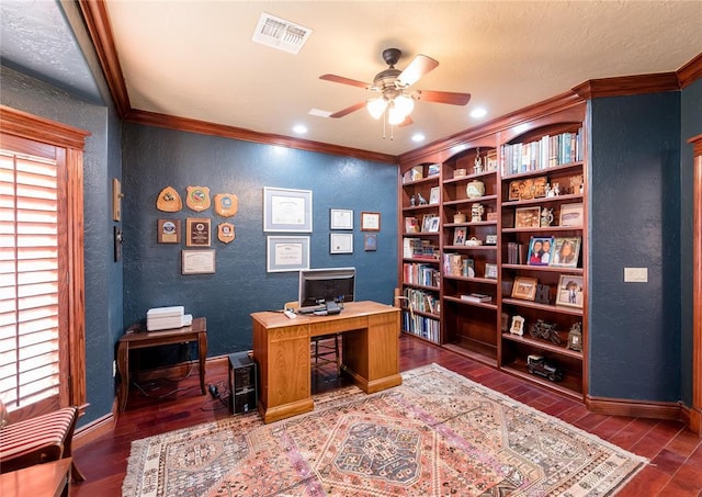 office with ornamental molding, dark wood-type flooring, built in features, and ceiling fan