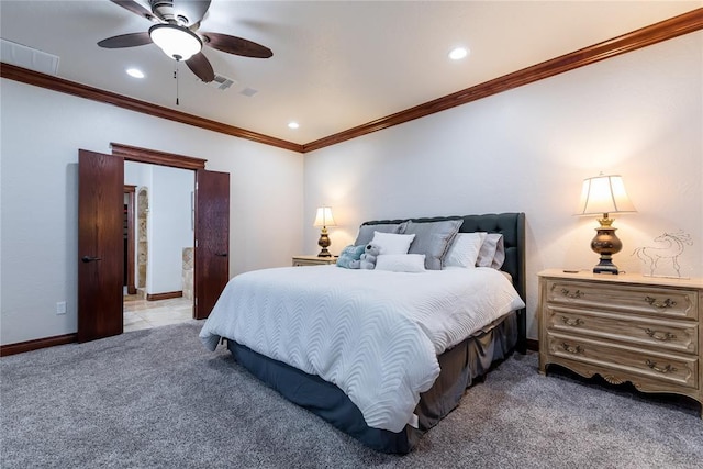 carpeted bedroom with ceiling fan and ornamental molding