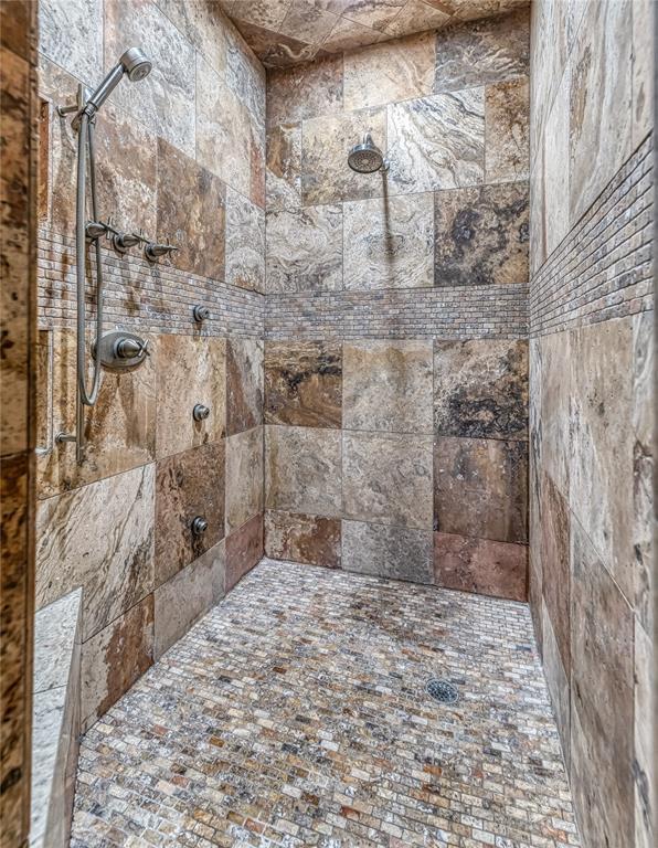 bathroom with tiled shower