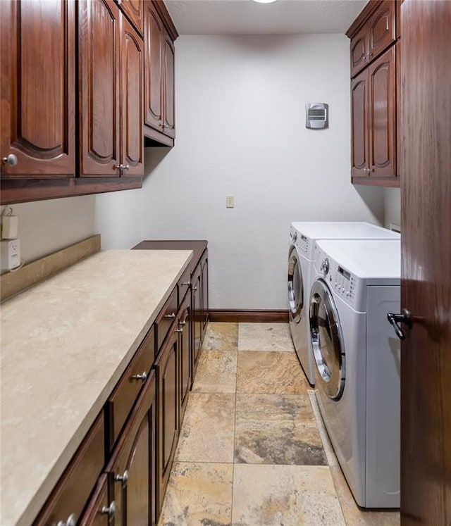 laundry room featuring cabinets and separate washer and dryer