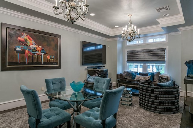 dining area featuring a tray ceiling, crown molding, and an inviting chandelier