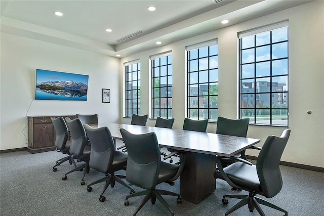 carpeted home office with a raised ceiling