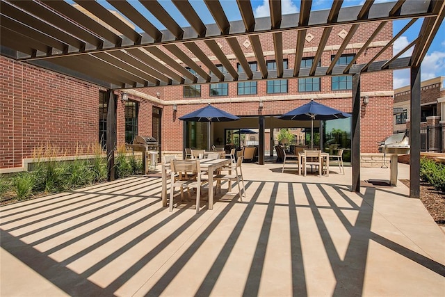 view of patio / terrace with a pergola and a grill