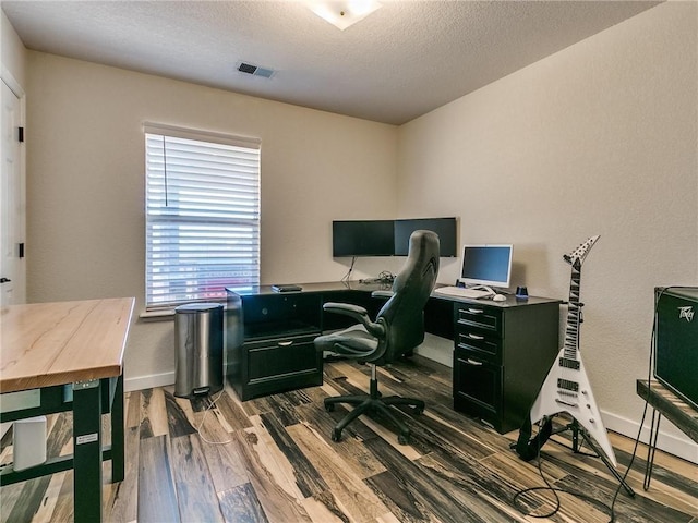 home office with hardwood / wood-style flooring, plenty of natural light, and a textured ceiling