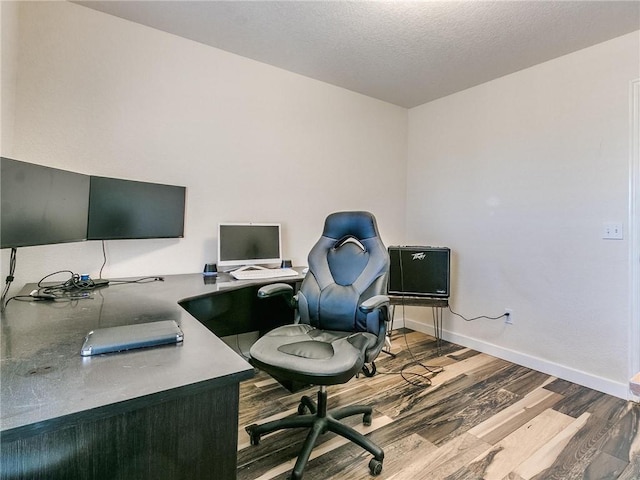 home office featuring a textured ceiling and hardwood / wood-style flooring