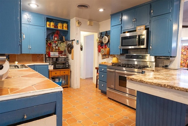 kitchen with tasteful backsplash, stainless steel appliances, and blue cabinets