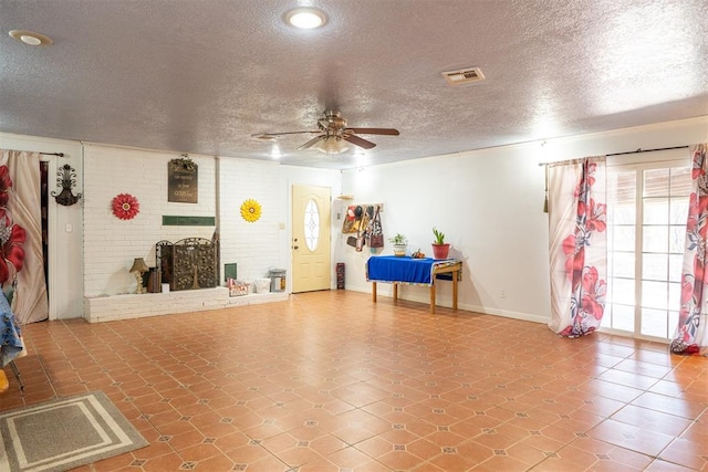 interior space featuring ceiling fan and a textured ceiling