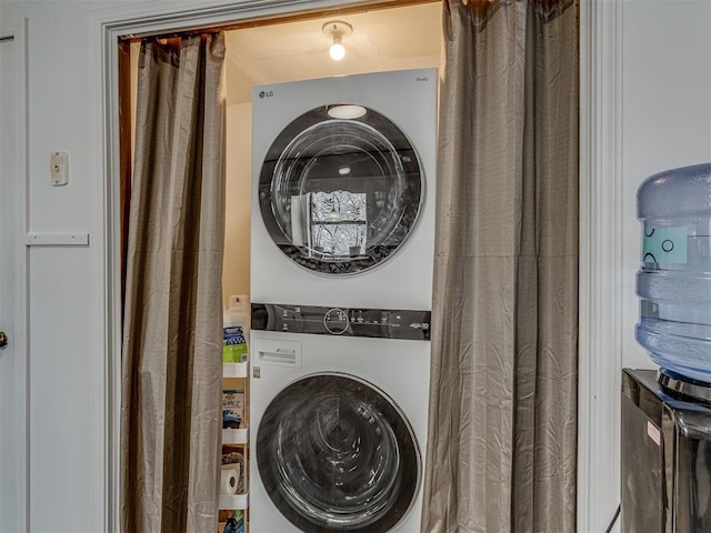 laundry area featuring stacked washer / drying machine