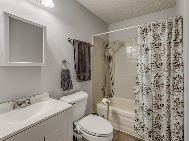 full bathroom featuring shower / bath combination with curtain, hardwood / wood-style floors, toilet, vanity, and a textured ceiling