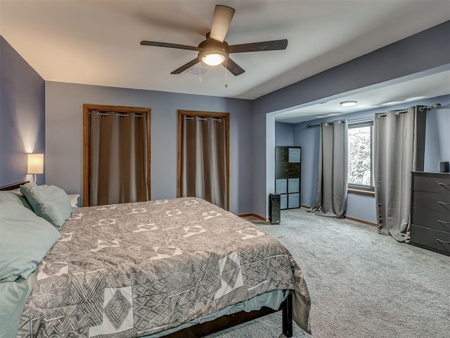 bedroom with ceiling fan and light carpet