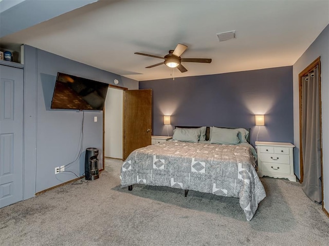 bedroom with light carpet and ceiling fan